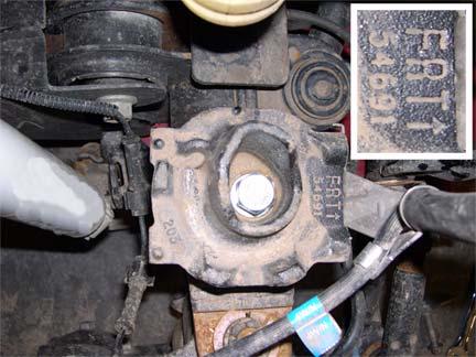 Remove upper spring isolator from spring and