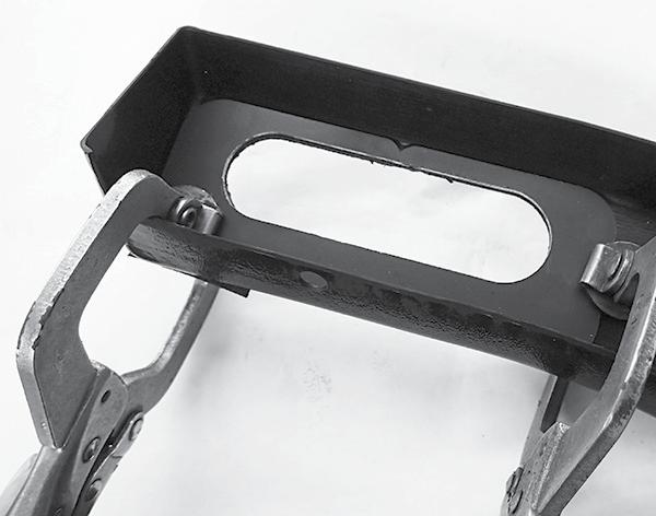 NOTE: Protect the front of the bezel where the clamps are attached to avoid scratching the plastic.