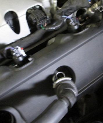 remove it from the vehicle. Remove the (2) Torx bit screws on the driver and passenger side coil covers.