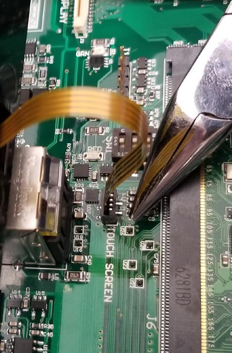 4. Remove the 4-pin ribbon cable from the TOUCH SCREEN connector on