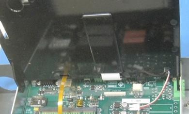 Insert the left or right hinge tab on the replacement LCD display assembly in