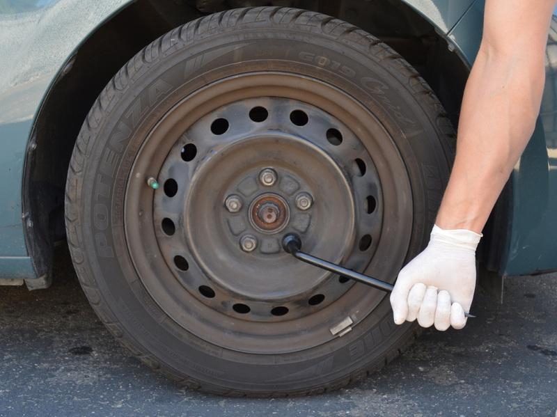 If you have steel wheels with wheel covers, use a large flat head screwdriver or the tip