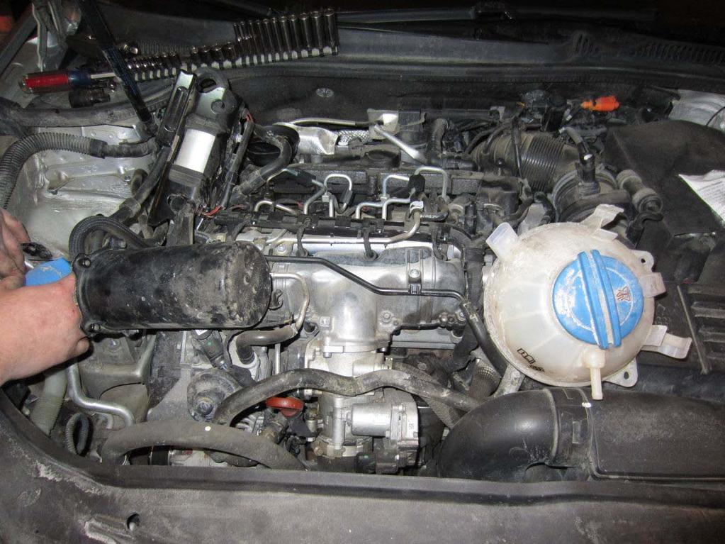 20. While lifting the aux fuel pump and the fuel filter, slide the coolant reservoir and supply line