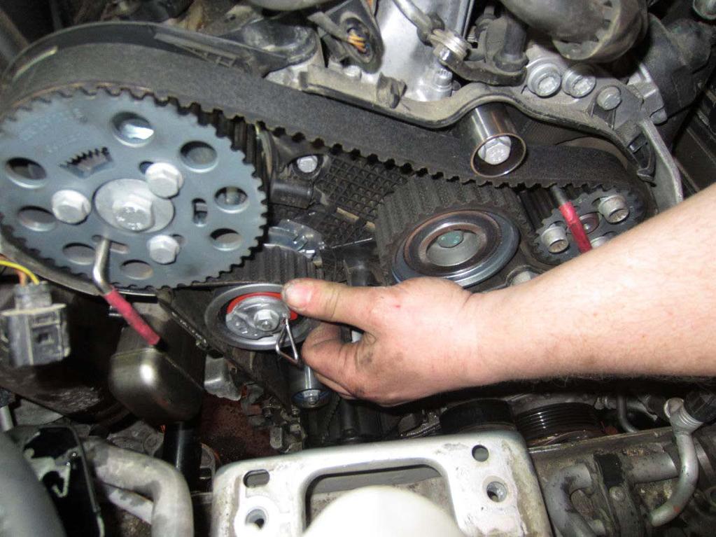 57. With your finger put some tension on the belt near the tensioner.