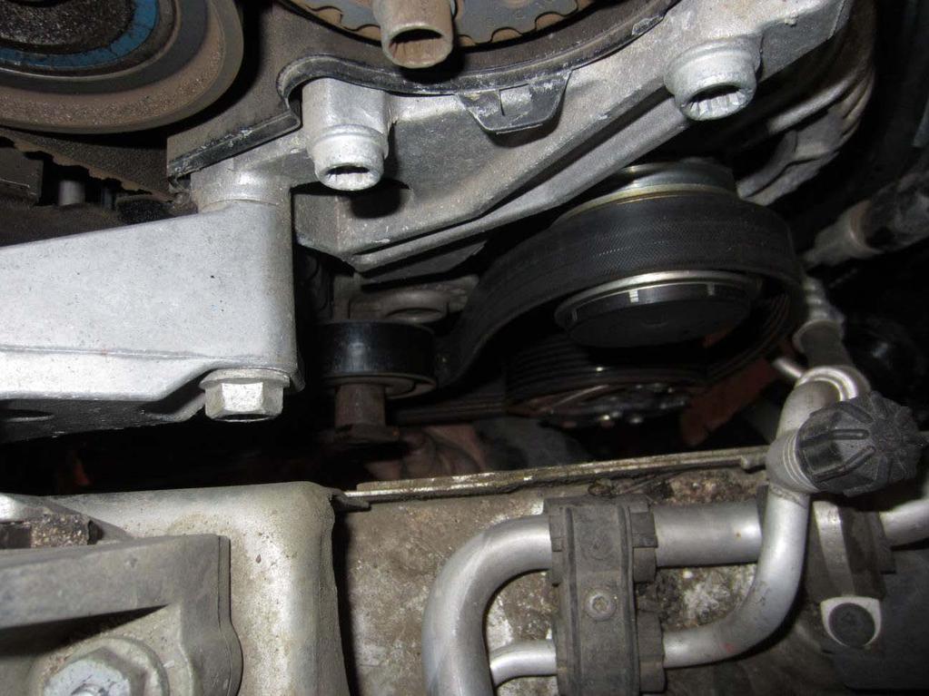 7. Remove ribbed belt (16mm on the tensioner). Rotate tensioner clockwise to release tension on belt. 8. Disconnect lower radiator hose (passenger side, above charge air tubing) and drain coolant. 9.