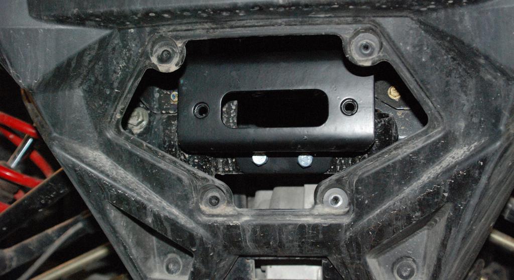 Install the two winch mounting brackets through the front opening.