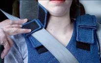 shoulder portion of the vehicle seat belt (Figure A). 2.