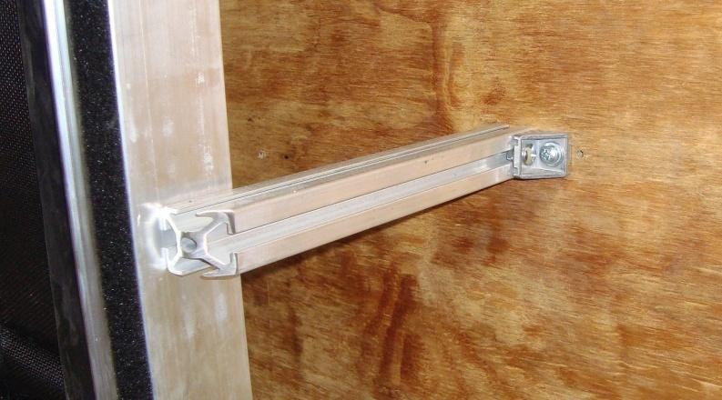 If necessary, remove the Phillips fastener and insert a washer between the aluminum standoff and the bracket to obtain this alignment. Reinstall the Phillips fastener.