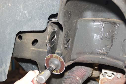 Remove the stock differential bracket on the passenger side using a 18mm & 15mm socket / wrench. See Photo 14. Front Photo 13 Photo 14 Driver Side Shown Passenger Side Shown 18.