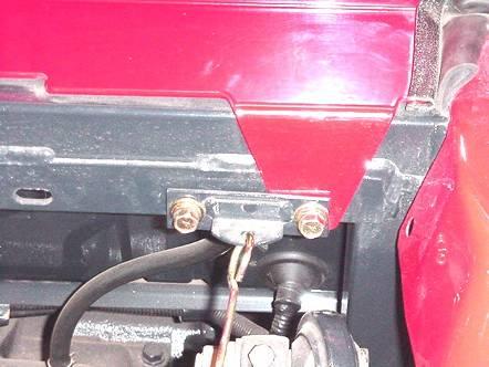 On each side of vehicle, remove three phillips head screws from floormat and two hex head bolts as