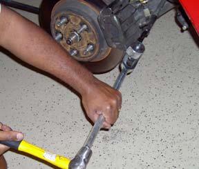 To avoid damage to the control arm, the tie-rod end splitting tool should be held at an orientation generally parallel to the axle centerline of the IRS. 2.