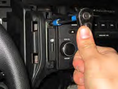 Remove the mounting screw. Pull the top of the dashboard away from the windshield.
