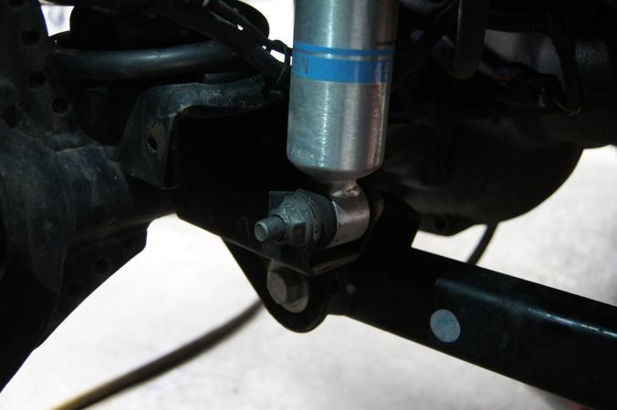 Install Procedure: After removal of the shock and before you begin any other work be sure to position the relocation bracket under the factory shock mount and check for clearance between the brake