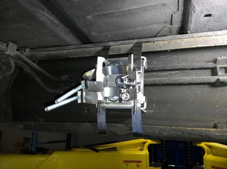 The clamps threaded section and nut can be on either side of the frame, just ensure it is away from any bracket or frame edges. Inside of frame Tighten the band straps until the bracket is snug.