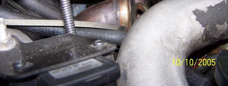 The end of the screwdriver is padded with duct tape and wedged into the vanes of the exhaust wheel of the