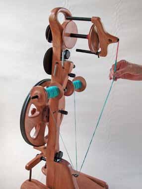 leader YARN 4. Draw the single yarns from the bobbins down toward the Plying Loop located between the treadles.