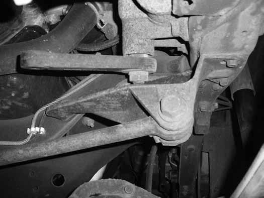 11. With all of the leaf spring bolts loose, support the passenger's side of the front axle with a jack. Remove the passenger's side spring u-bolts. Lower the axle away from the spring.