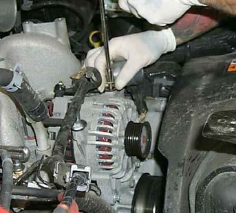 Figure 22 22. Remove the serpentine belt by rotating the tensioner clockwise using a 1/2 breaker bar. Figure 23 