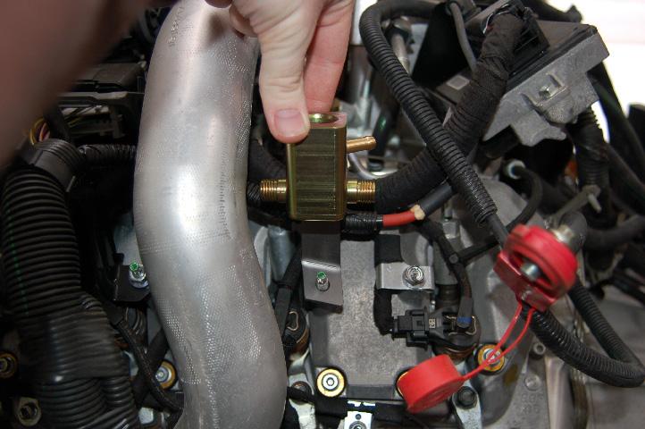 Route the #4a high pressure line under the radiator hose as shown