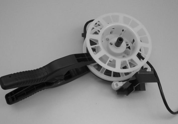 3. Clamp the cord reel to the body of the cord reel assembly to immobilize it. See Figure 010-8.