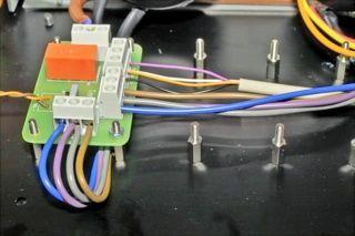 TR2 (middle transformer) Grasp the four primary wires in their black socks. Twist purple and grey together (as depicted above) and fix them into the middle of connector 'TR2' on the mains PCB.