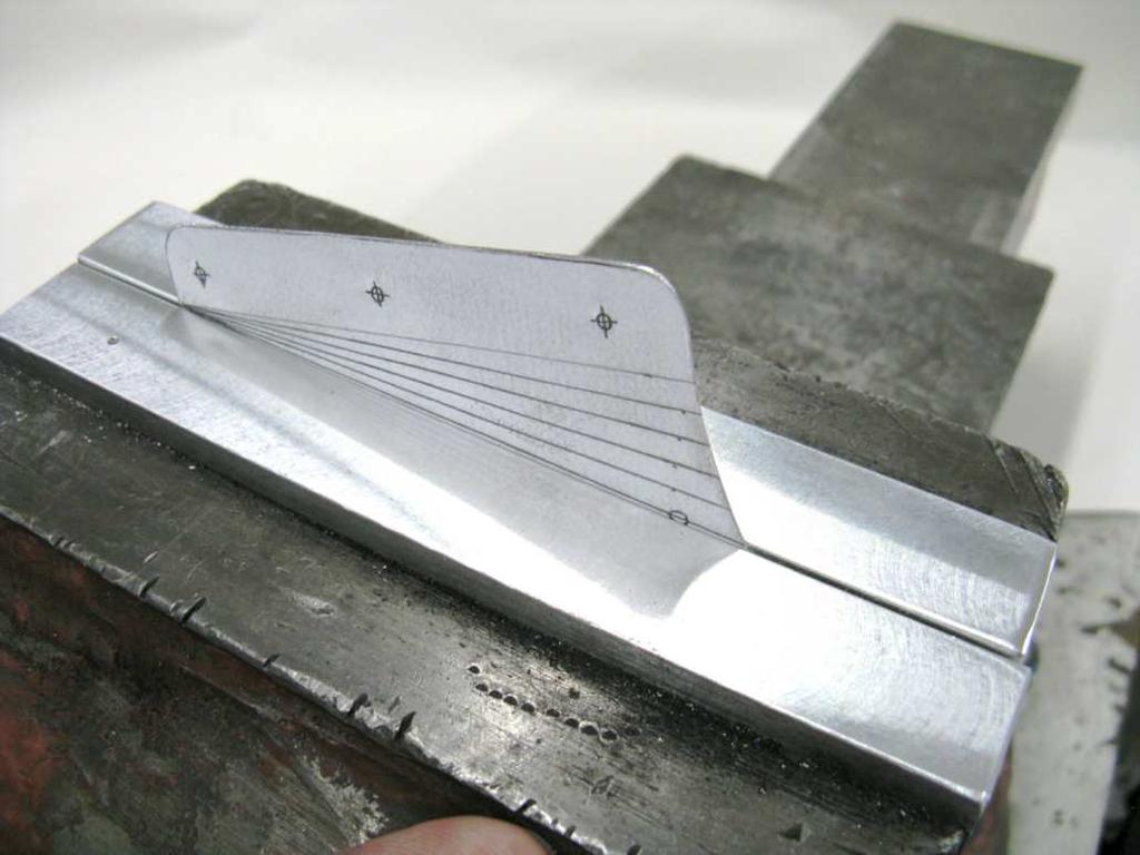 If required, use two pieces of scrap aluminum angle as jaw caps. NOTE: Practice the following steps on a piece of.032 in. [0.8 mm]-thick scrap aluminum before bending the actual part.