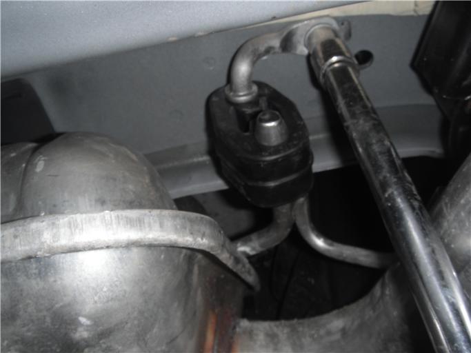 On V8 Models: Reattach driver side muffler onto studs with