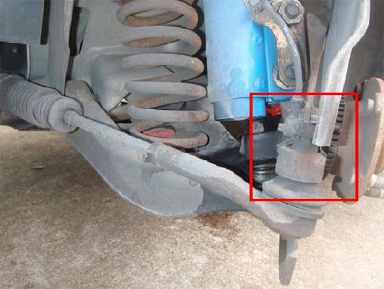 5. Next, you need to break loose the tie-rod nut, which is pictured below. This is where you will need the driver s license or credit card.