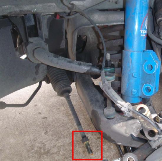 7. Once the tie-rod end is free from the spindle, turn it counter-clockwise until it comes off the tie-rod. You will see yellow grease on the tie rod threads this is normal.