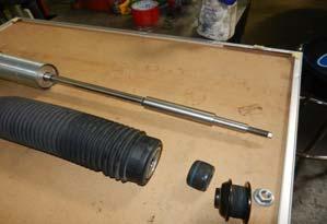Remove the boot from the shock and place in a vice or suitable clamp.