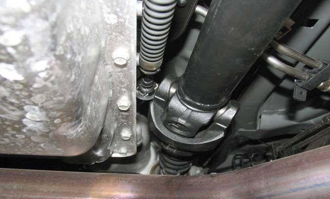 Double Cardan Driveshaft Installation: 2) Loosen the clamp attaching the slip-yoke boot to the transfer case output shaft and slide boot forward off of output shaft.