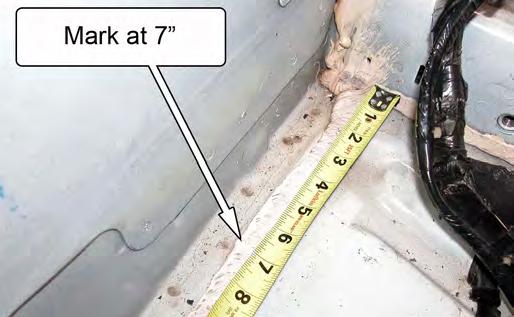 Using a wood chisel or other sharp scraping tool, remove any seam sealer located between the corners of the floor pan and the marks made in the previous steps.