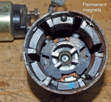 As the armature is pulled and pushed by the interaction of the magnetic fields, the commutator segment that was supplied power becomes the ground side of the circuit.