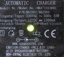 The charger has a current. LED lamp lights Green. Battery is charged.
