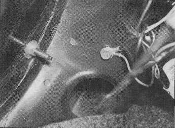 17 Slacken and remove the rear light cluster retaining nut, then free the light cluster from the rear of the vehicle, and disconnect its wiring connector (see illustrations).