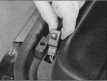 22 Disconnect the wiring connector from the handbrake switch, then undo the retaining screw and remove the switch from the side of the handbrake lever (see illustration).