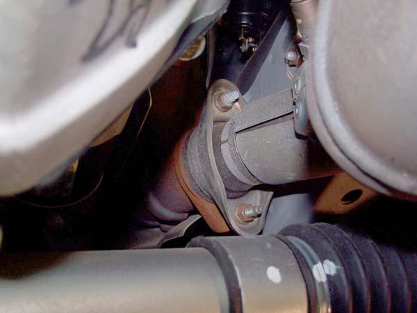 Loosen the two nuts on the two tail-pipe flanges and remove the two bolts at the front