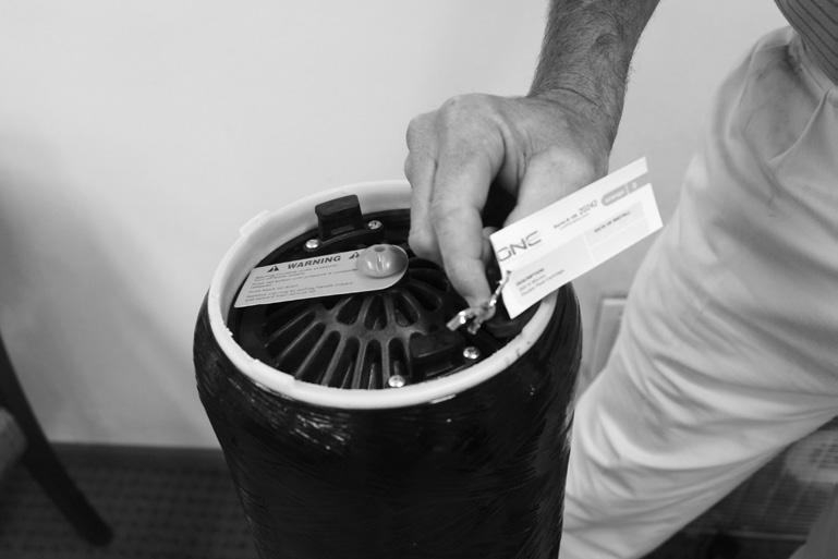 Attach product description tag to retaining ring handle for future reference (see Fig. 5). Fig. 4 11. Replace top cap of tank using top handles. 12.
