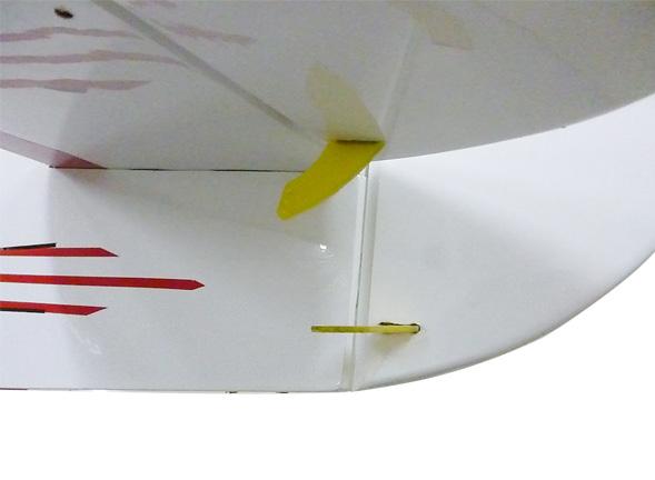 Epoxy. Apply a thin layer to the mounting slot and to bottom of the vertical stabilizer mounting area.
