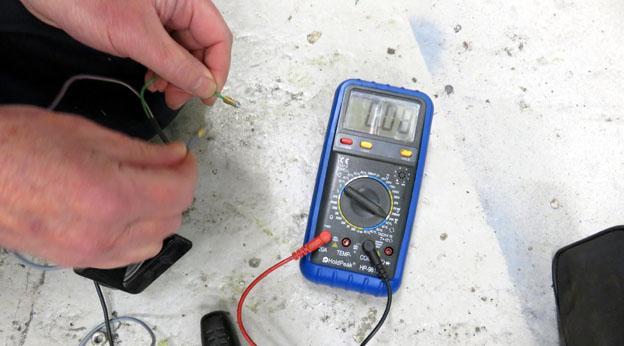 To check current you put the meter in series from the battery positive. The red lead was connected to the battery.
