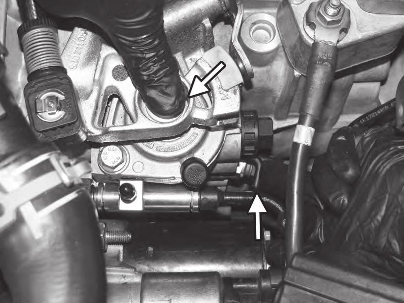 13) After making sure the car is in neutral, locate the neutral locking pin under the shift selector, directly above the reverse switch. Carefully push the locking pin in towards the shift selector.