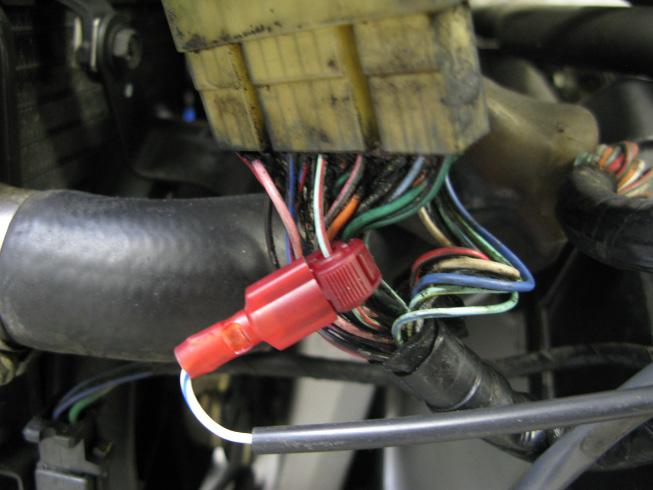 that goes to the dash cluster. Next, locate the factory neutral wire (light green /red wire) on this connector.