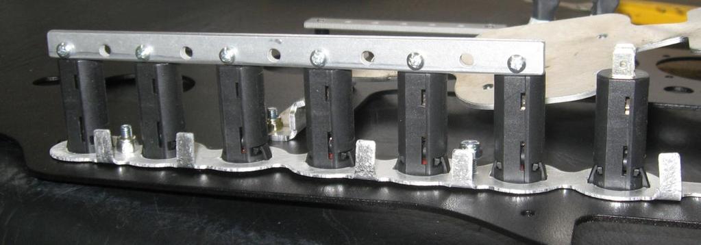 Bolt the main busbar across the lower side of the bottom contacts on the 5 and 10 amp circuit breakers only using the M3 silver screws and Nyloc nuts as shown above.