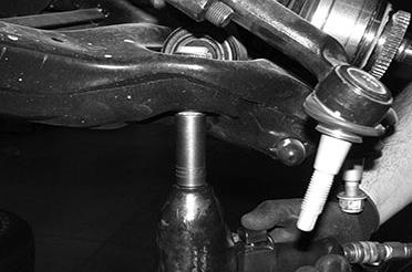Use extra care not to over extend the C.V. axle shaft when removing the knuckle.