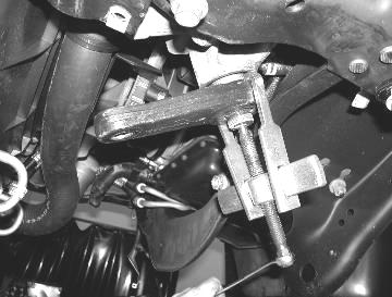 Save the lower shock hardware and discard the rest of the hardware. 4. Lower the front axle allowing the coil springs to come free of tension.