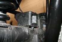 Before installing the new rear springs, install the rear coil spring guide and spacer by pushing it into the hole in the frame directly above the rear coil spring.