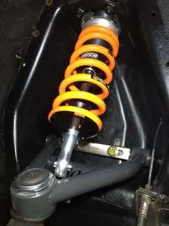 Figure 11 Coilover shock partially installed. 7. Push the upper control arm downward and insert the lower shock eyelet into the upper control arm.
