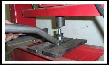 Using a press or a vise is suggested for removing and replacing the ball