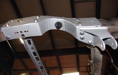 It is bolted in place using (6) 7/16 x 1 ¼ bolts, Nylok nuts and flat washers. Note: There are four holes on each side of the bridge; only 3 will be used. 13.