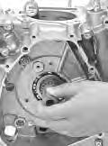 Take extreme care not to let BOND 1215 enter into the oil hole or bearing. Install the crankcase.